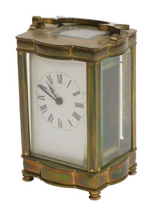 A late 19thC serpentine fronted brass cased carriage clock, rectangular dial bearing Roman...