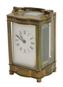 A late 19thC serpentine fronted brass cased carriage clock, rectangular dial bearing Roman...