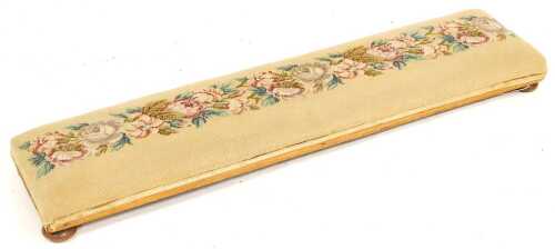 A floral woolwork upholstered fender stool, with bun feet, 110cm long.