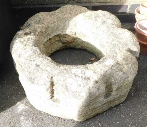 A stone well head, possibly Medieval, of crenellated circular form, 58cm wide.