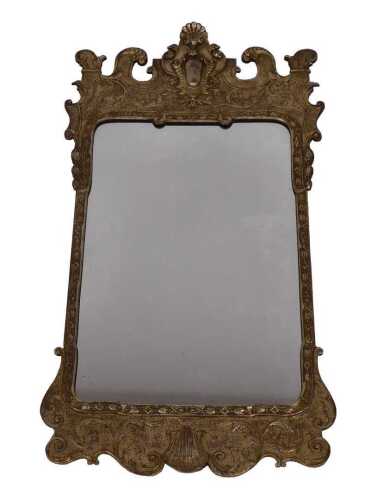 A mid 18thC style gilt wall mirror, the shaped crest decorated with scrolls, etc., around a...