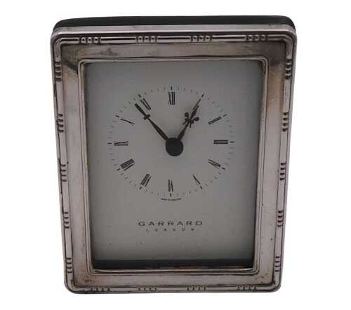 An Elizabeth II rectangular silver backed strut clock, dial bearing Roman numerals, Garrard and...