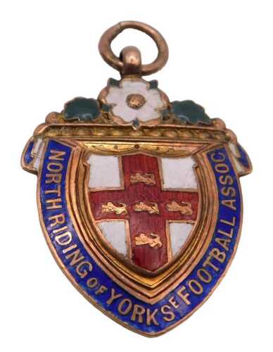 A 9ct gold and enamel shield shaped medal, for the North Riding of York SE Football Assoc,...
