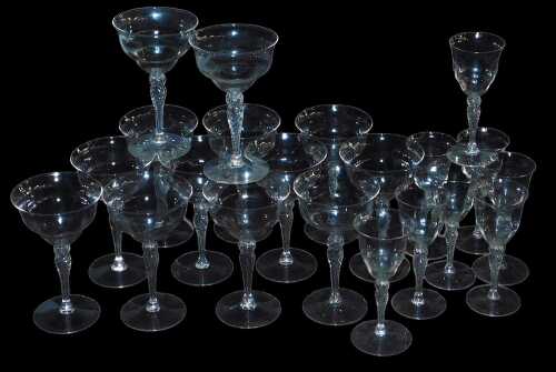 Thirteen wine glasses, each with a finely twisted stem, and eight matching liqueur glasses. (21)