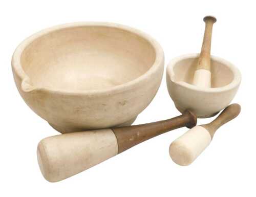 A large pestle and mortar, the pestle with a wooden handle, 31cm diameter, another pestle and...