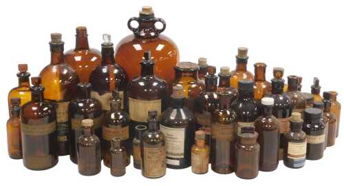 A quantity of brown glass chemist's jars, various sizes, some with original labels. (2 trays plus)