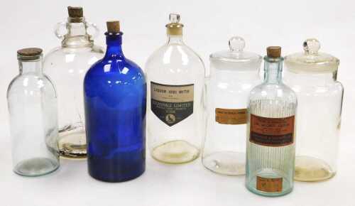 A quantity of chemist's bottles and a measure, etc., some with original labels. (2 trays)