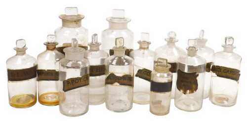 A quantity of late 19th/early 20thC chemist's bottles, some with printed and painted labels, to...