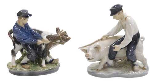 A Royal Copenhagen porcelain figure group of a young boy with pig, numbered 848 to underside,...