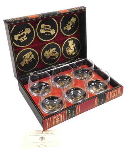 A leather fitted case, containing a set of six liqueur glasses and coasters, each with gilt...