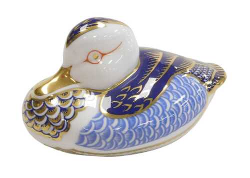 A Royal Crown Derby Imari porcelain duck paperweight, gold button, 11cm wide.