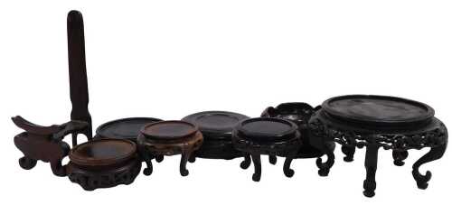 A Chinese red and black lacquer stand, 14cm diameter, and six other Chinese stands.