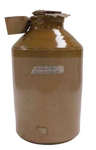 A large stoneware bottle, with partial label for Salicylas B.P, distributed in Leeds, with cork...