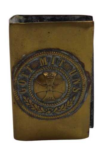 A World War I German brass matchbox holder, embossed with an iron cross, within a circular frame...