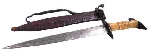 A 20thC Sudanese arm dagger, with a carved bone grip, and carved wooden pommel and guard, with a...