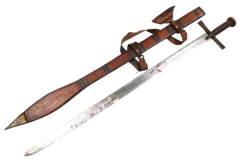 A 19thC Sudanese kaskara sword, with a channelled and engraved steel blade, iron guard and...
