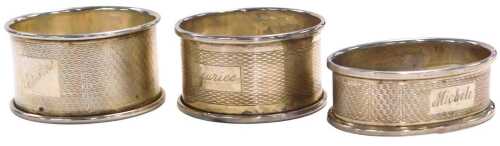 A George VI silver napkin ring, with engine turned decoration, rectangular reserve engraved...