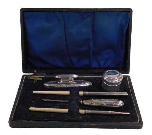 An early 20thC silver plated three piece manicure set, comprising a cuticle pusher, ointment jar,...