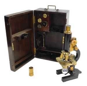 A late 19thC brass and black Japanned monocular compound microscope, with additional lenses, cased.