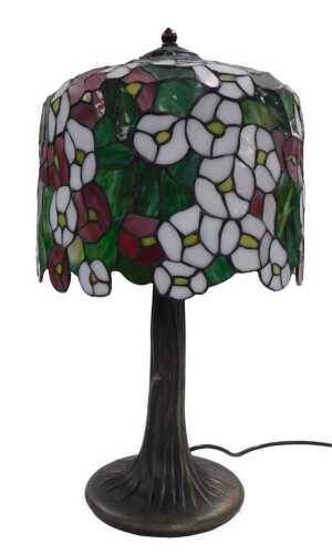 A Tiffany style lamp, the cylindrical floral leaded shade decorated with white and pink flowers,...