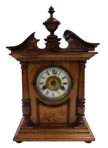 A late 19th/early 20thC German walnut mantel clock, the dial with Roman numerals above a...
