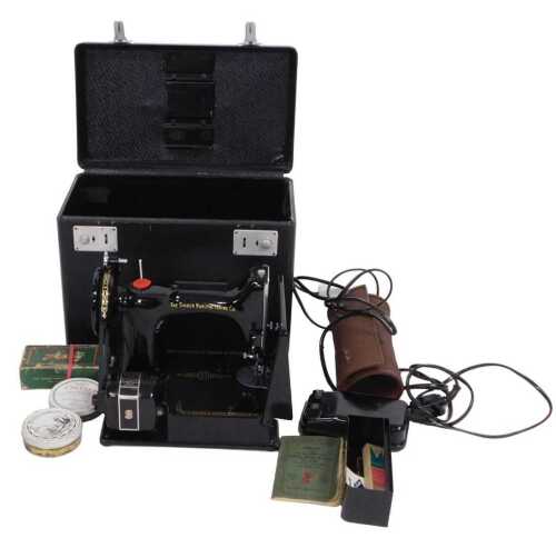 A Singer 221K Featherweight portable electric sewing machine, 29cm wide, with a black carrying...