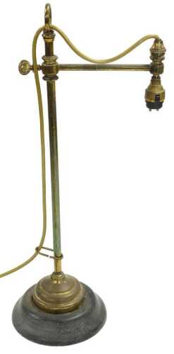 An early 20thC brass desk lamp, with a black painted iron base, 52cm high.