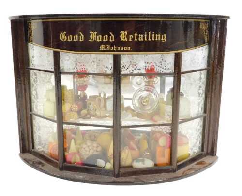A diorama of a shop window by M Johnson, titled Good Hood Retailing, in a mahogany case, 19cm...
