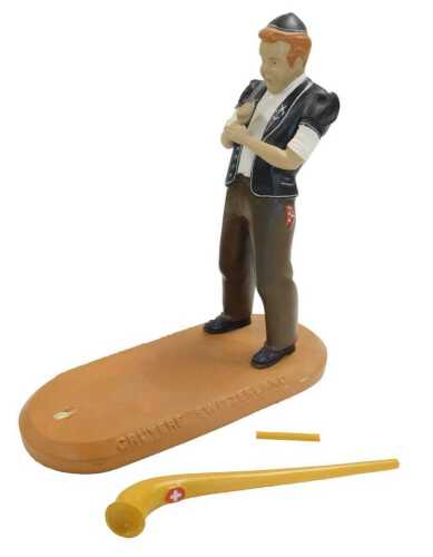 A painted composition shop display model, in the form of a Swiss horn player, stamped to base...
