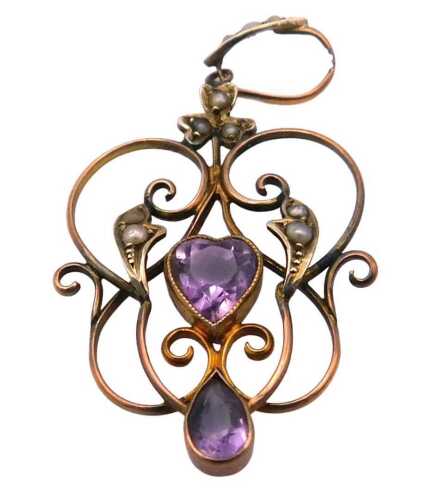 An Edwardian amethyst and seed pearl pendant, in an openwork scrolling frame, in rose metal,...