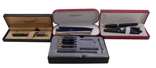 A Sheaffer fountain pen, in a grey marbled casing, further Sheaffer fountain pen, black cased,...