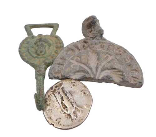 A Tudor brass clothing hook fastener, a Hadrian silver denarius 117-138AD, and a lead cast half...
