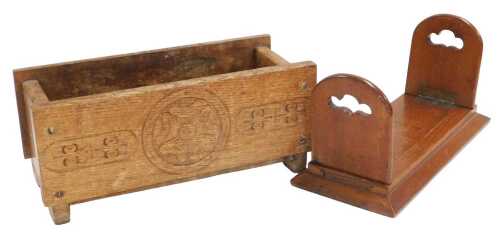 An early 20thC oak trough, carved with a Tudor rose, 38cm wide, together with an early 20thC oak...