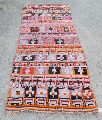 A Moroccan Berber vari-coloured runner, with bands of geometric motifs, 344cm x 140cm. Retailed...