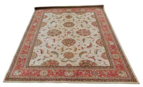 An Indian style machine woven carpet, with an all over design of flowers and leaves, on a cream...