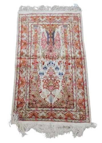 An Eastern silk Qum prayer rug, with an arched design, with a tree of flowers, birds, etc., one...