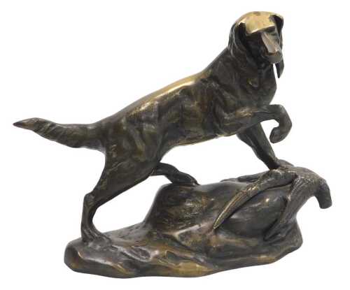 A brass figure of a setter, above a dead gamebird, raised on a rocky base, 34cm wide.