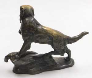 A brass figure of a setter, above a dead gamebird, raised on a rocky base, 34cm wide. - 2
