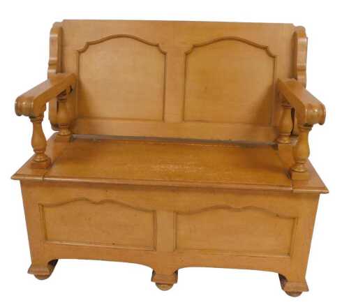 A Victorian light oak monk's bench, with a rectangular top, raised on scrolling arms on baluster...