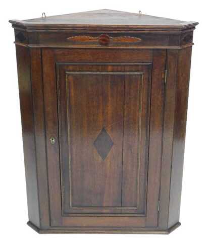 A George III oak hanging corner cupboard, 96cm high.