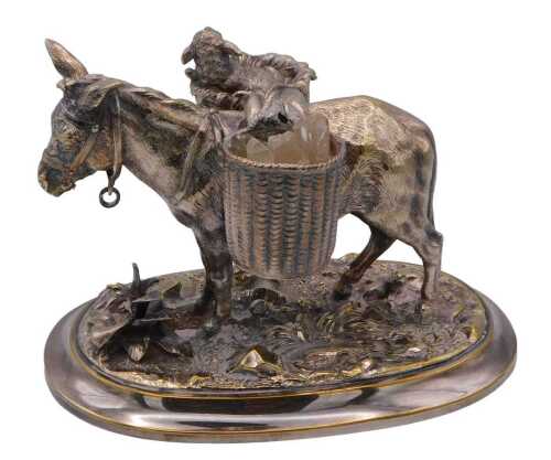 A late 19thC silver plated model of a donkey, with two baskets across its back, one holding a...