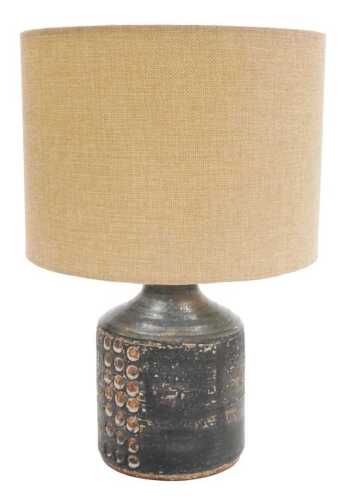A late 20thC studio pottery table lamp, of cylindrical form, with a black lace and pressed...
