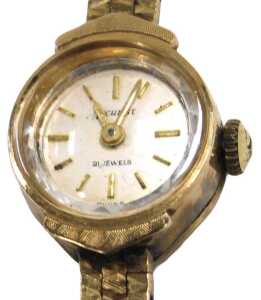 An Accurist lady's 9ct gold cased wristwatch, circular silvered dial with baton markers, in a...