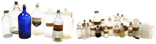 A quantity of chemist's bottles and a measure, etc., some with original labels. (2 trays)