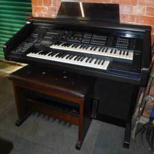 A Technics electric organ, together with a stool.