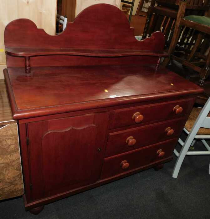 A stained pine Lincolnshire chest, the top with a raised back and shaped shelf, above a panelled...