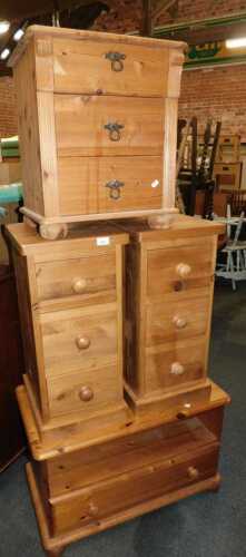 A group of pine bedroom furniture, comprising a pair of three drawer bedside chests, a...