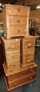 A group of pine bedroom furniture, comprising a pair of three drawer bedside chests, a...