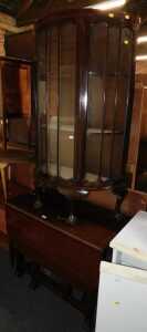 A mahogany drop leaf table, together with a mahogany bow fronted display cabinet, raised on ball...