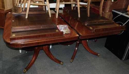 A mahogany twin pedestal extending dining table, 74cm high, the top 160cm x 110cm, with two...